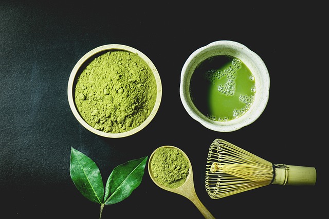 A cup of matcha tea with vibrant green powder in a bowl beside it, showcasing the rich color and smooth texture of the matcha, which is known for its weight loss benefits.